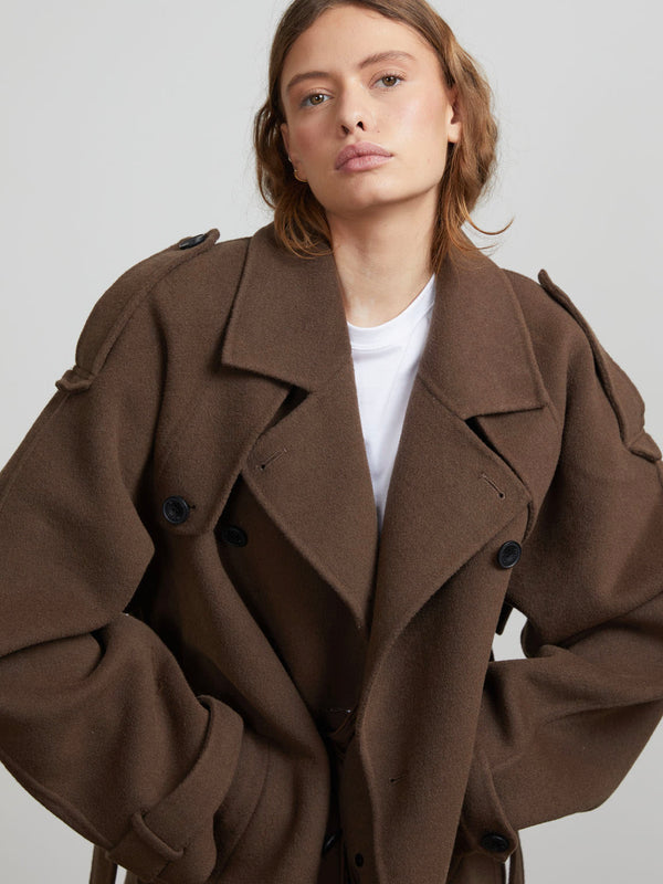 A model wearing a stylish oversized brown coat with a double-breasted design, showcasing MEOTINE's contemporary fashion.