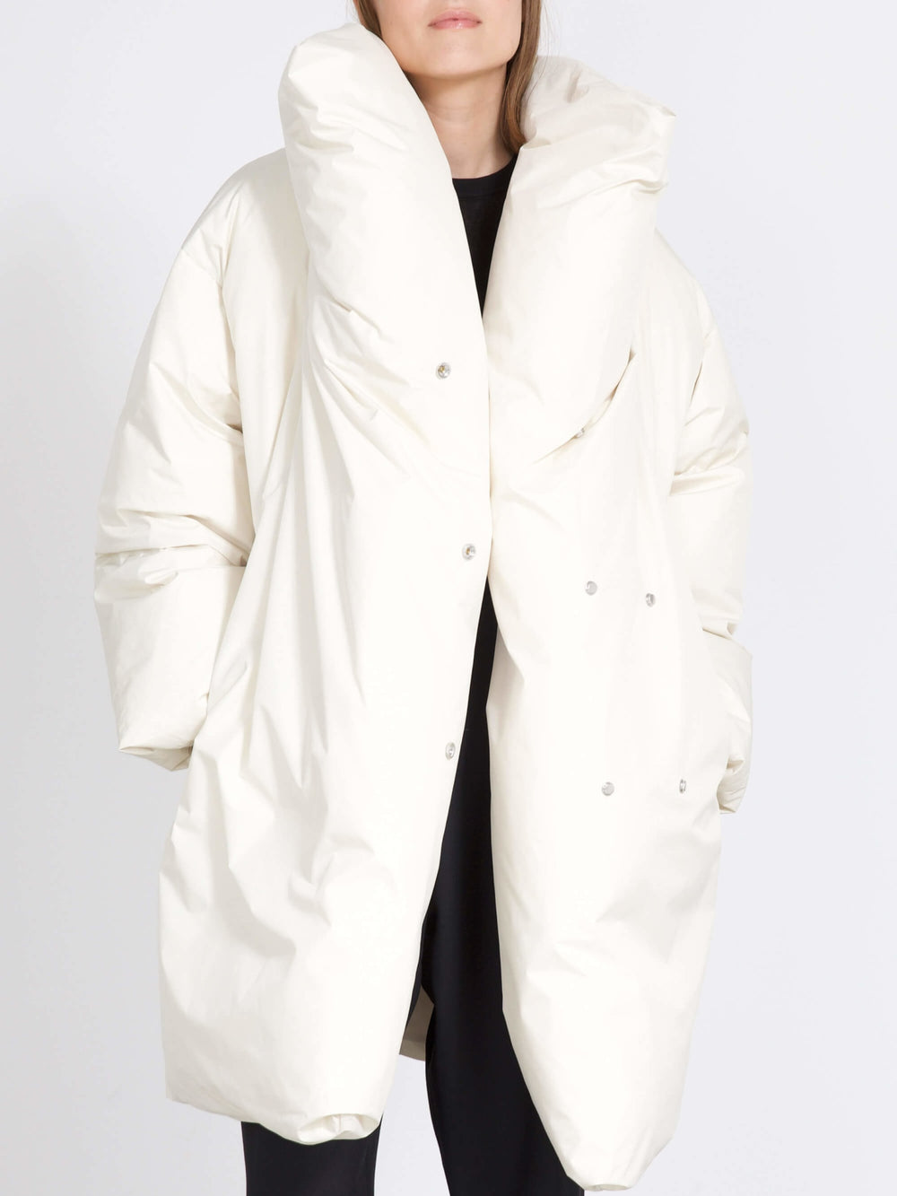 Oversized white puffer coat with a dramatic collar, featuring snap buttons, perfect for a stylish winter look by MEOTINE.
