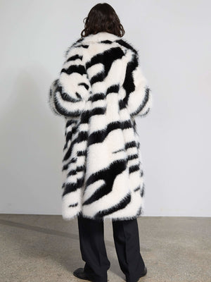 Stylish black and white striped faux fur coat by MEOTINE, featuring a cozy oversized fit and elegant design.