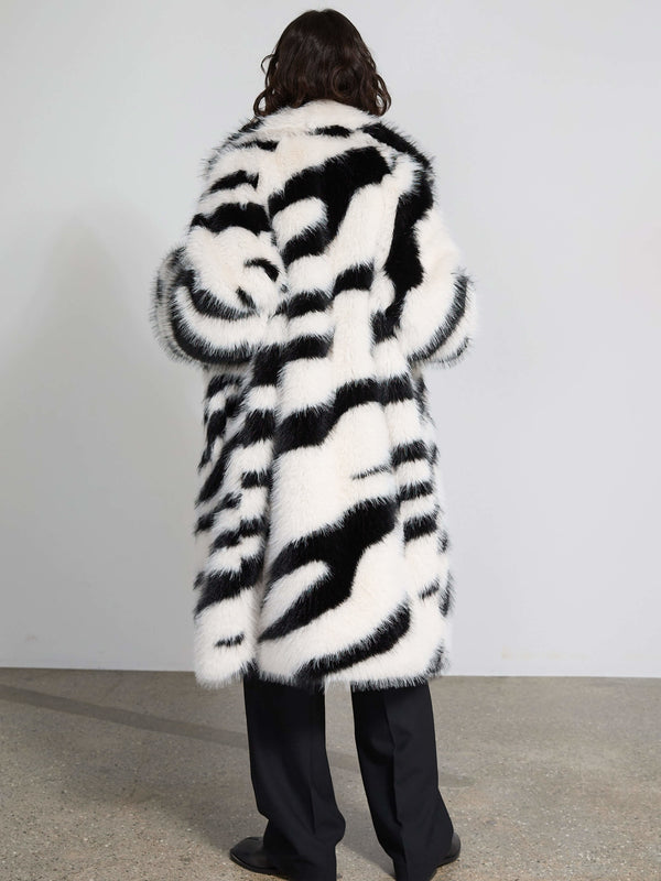 Stylish black and white striped faux fur coat by MEOTINE, featuring a cozy oversized fit and elegant design.