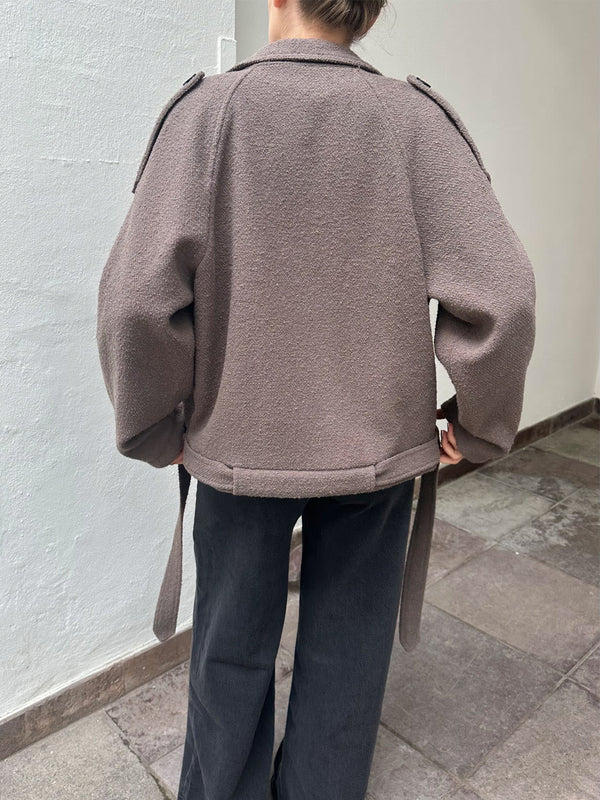 A model wears a cozy, oversized brown jacket with unique shoulder details, paired with wide-leg black pants, showcasing MEOTINE's style.