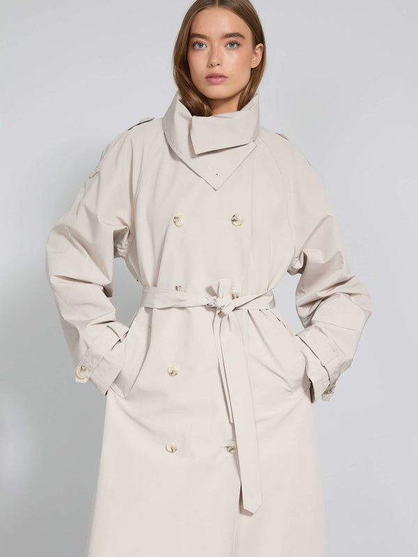A model showcases a stylish beige trench coat with a belted waist and high collar, embodying MEOTINE's modern elegance.