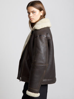 Brown leather jacket with a cozy shearling collar, showcasing a stylish and warm design by MEOTINE.