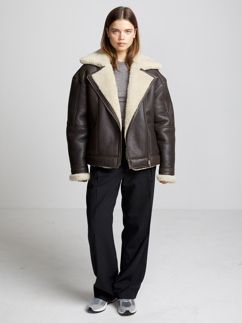 A model wears a stylish brown shearling jacket with a cozy cream collar, showcasing MEOTINE's chic winter fashion.