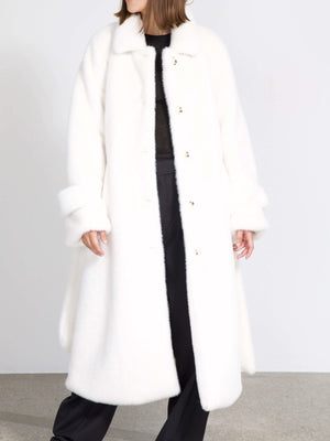 A model wears a cozy, oversized white coat with a soft texture and button closure, showcasing MEOTINE's stylish winter fashion.