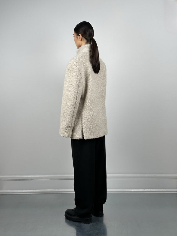 Cozy cream-colored fleece jacket from MEOTINE, featuring a relaxed fit and a high collar, styled with loose black pants.
