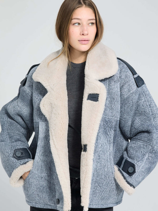 Cozy oversized jacket with a soft fur collar and textured fabric, perfect for a stylish winter look by MEOTINE.